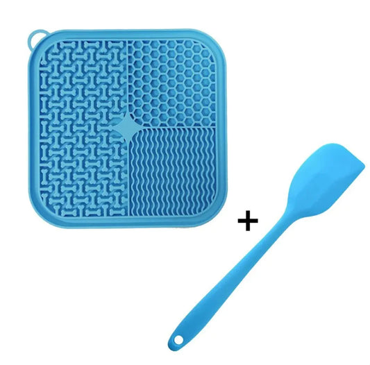 Blue silicone mat with textured design and a blue spatula on a white background