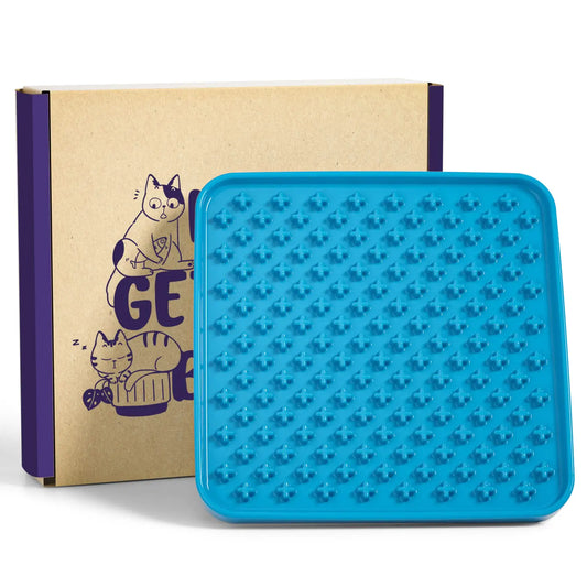 Blue silicone mat with textured surface next to a cardboard box with cat illustrations.