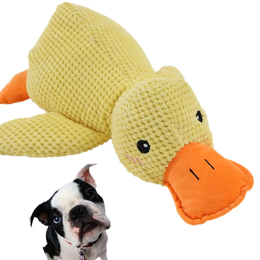 Crocheted duck toy with a dog looking at it on a white background