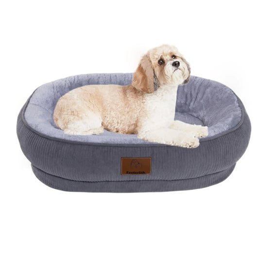 Dog lying on a gray pet bed with a visible brand label on a white background