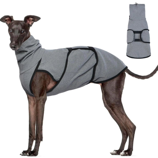 Dog wearing a gray calming anxiety jacket coat with a matching bag on a white background