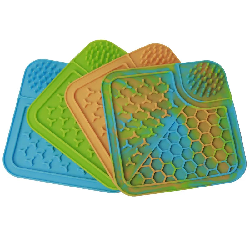 Four colorful silicone mats with textured surfaces on a white background